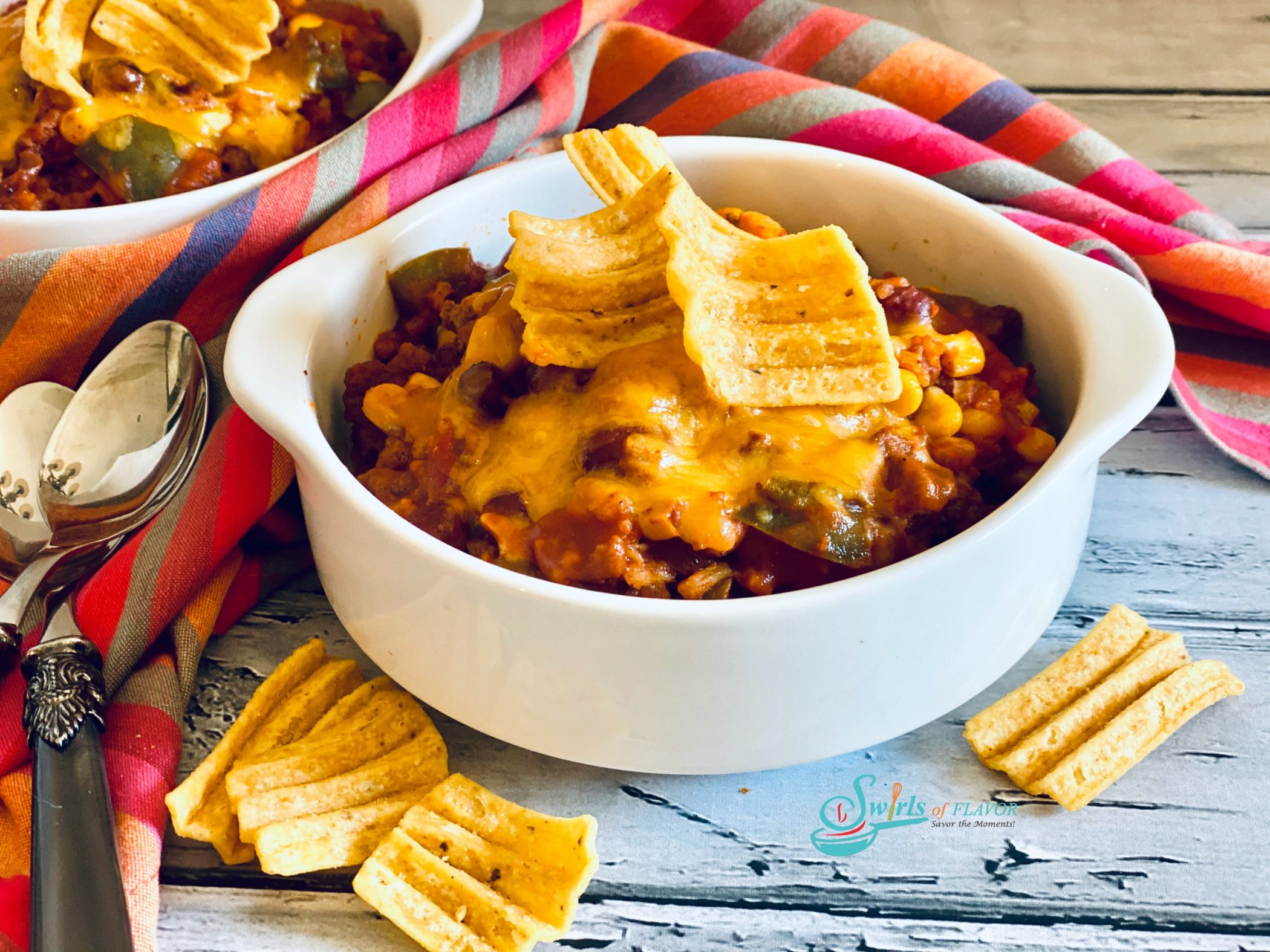 bowls of beef chili with corn chip topping