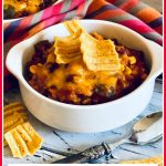 ground beef chili in white bowl with text overlay