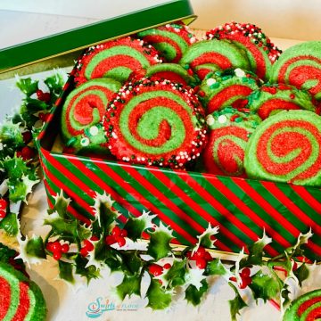 red and green pinwheel cookies in a cookie tin
