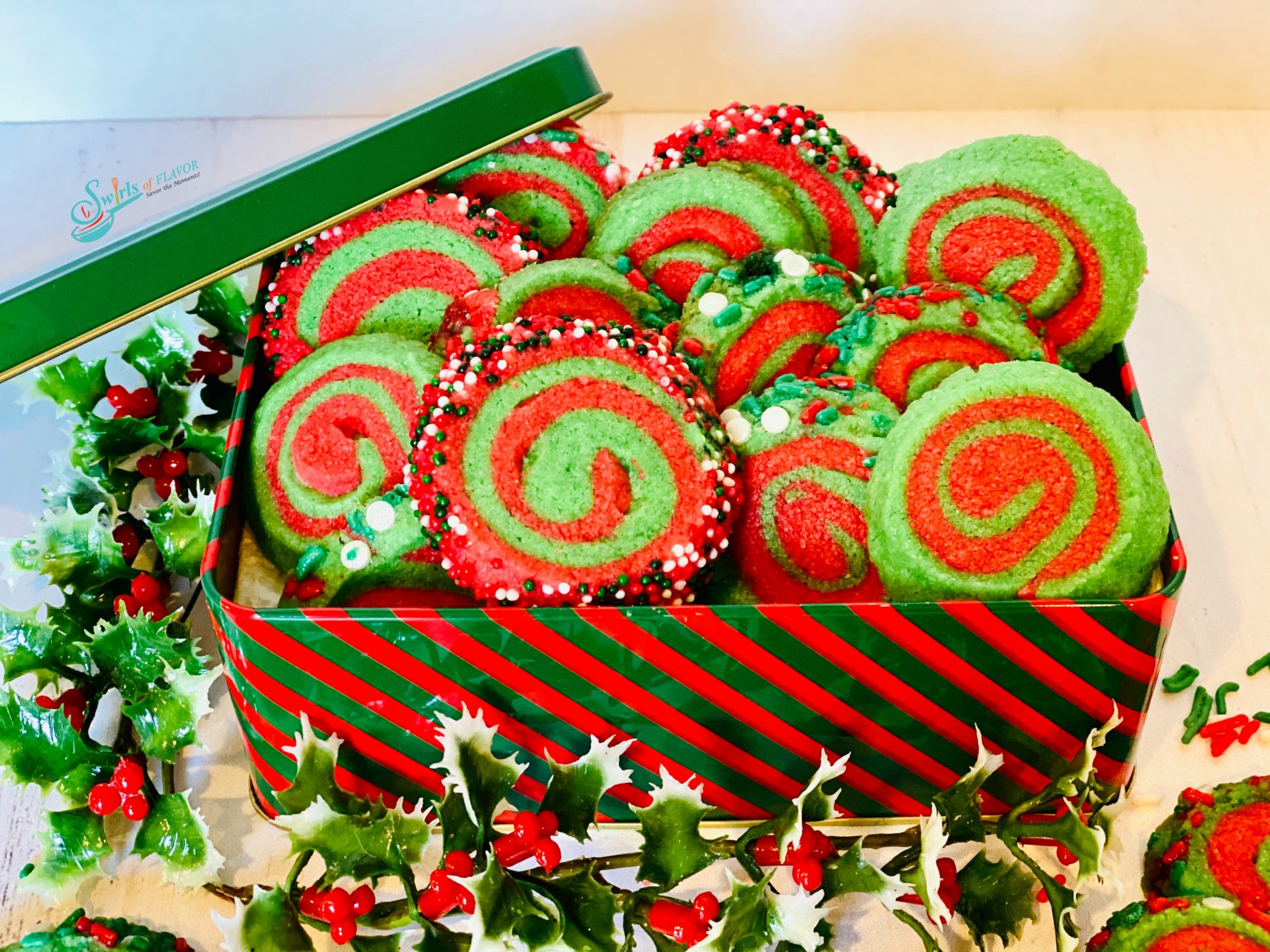 red and green Christmas pinwheel cookies in cookie tin