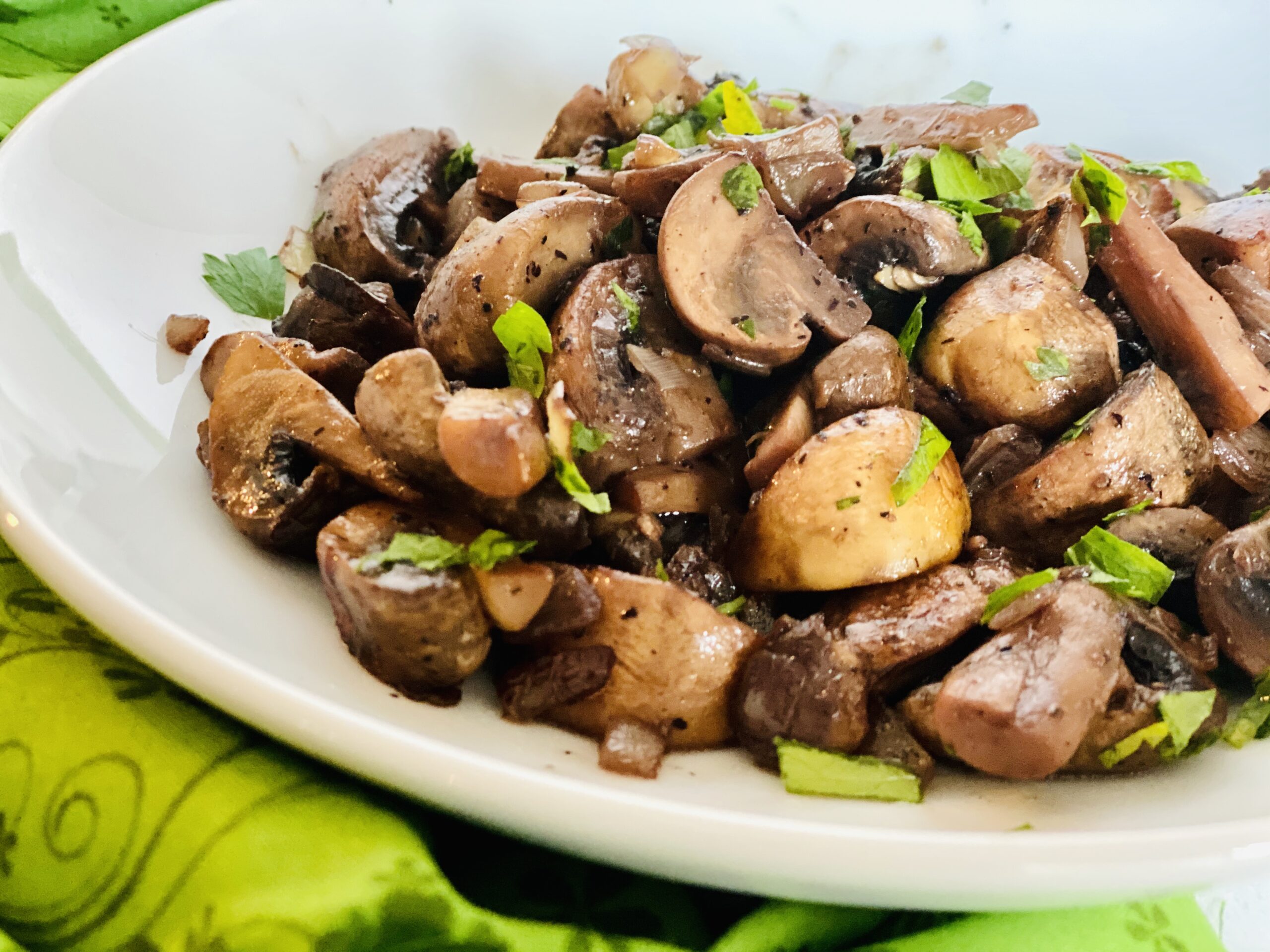 easy sauteed mushrooms and onions in white dish