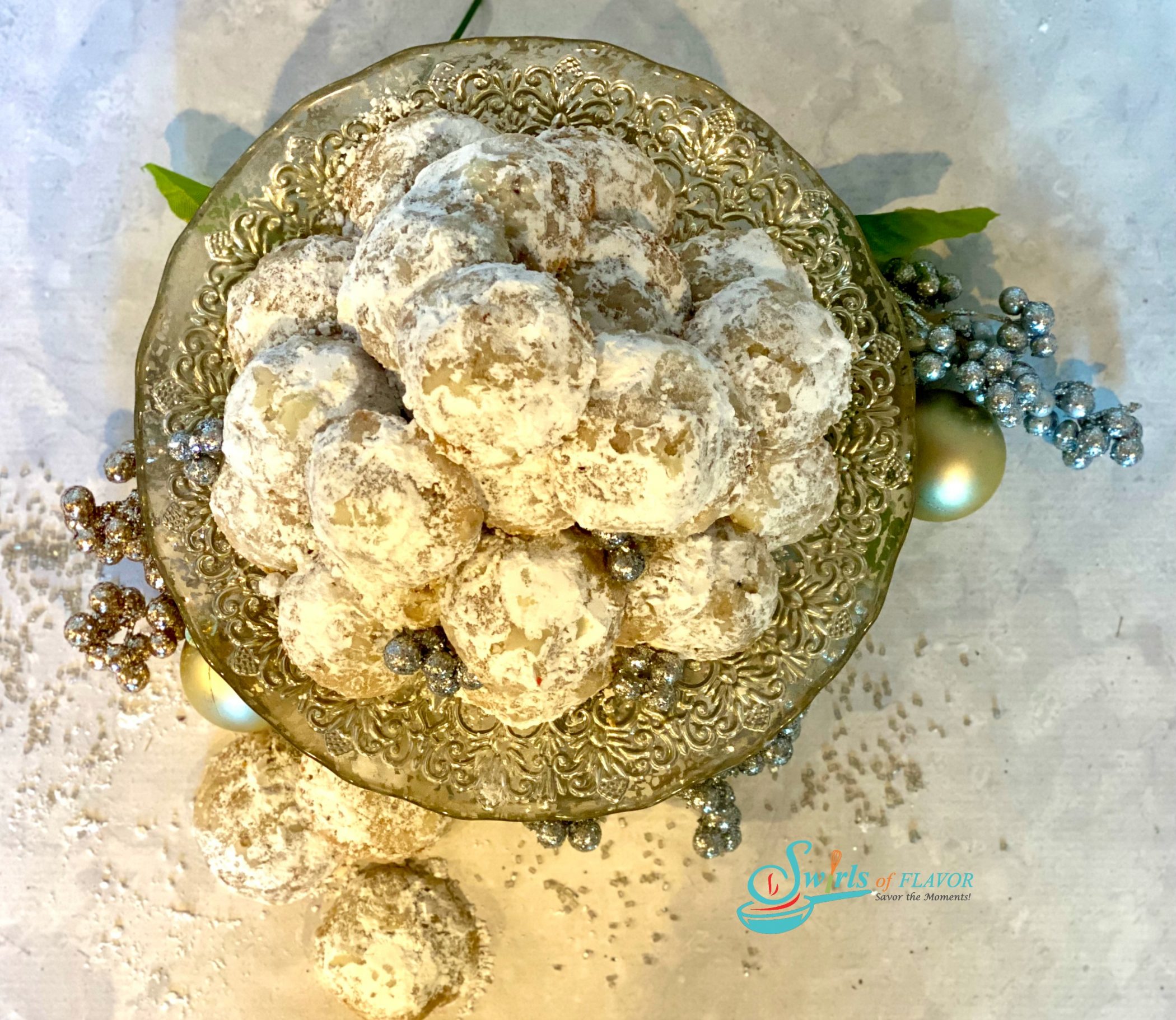 overhead photo of snowball cookies on a cake stand