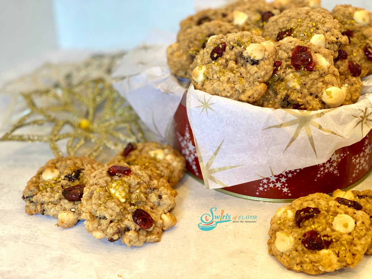 white chocolate cranberry oatmeal cookies with tin of cookies and glitter snowflake