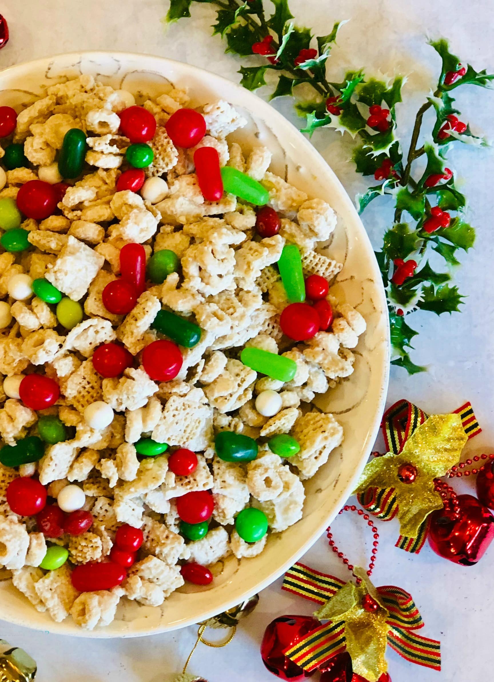 overhead photo of bowl of cereal and holiday candy with Christmas ornaments