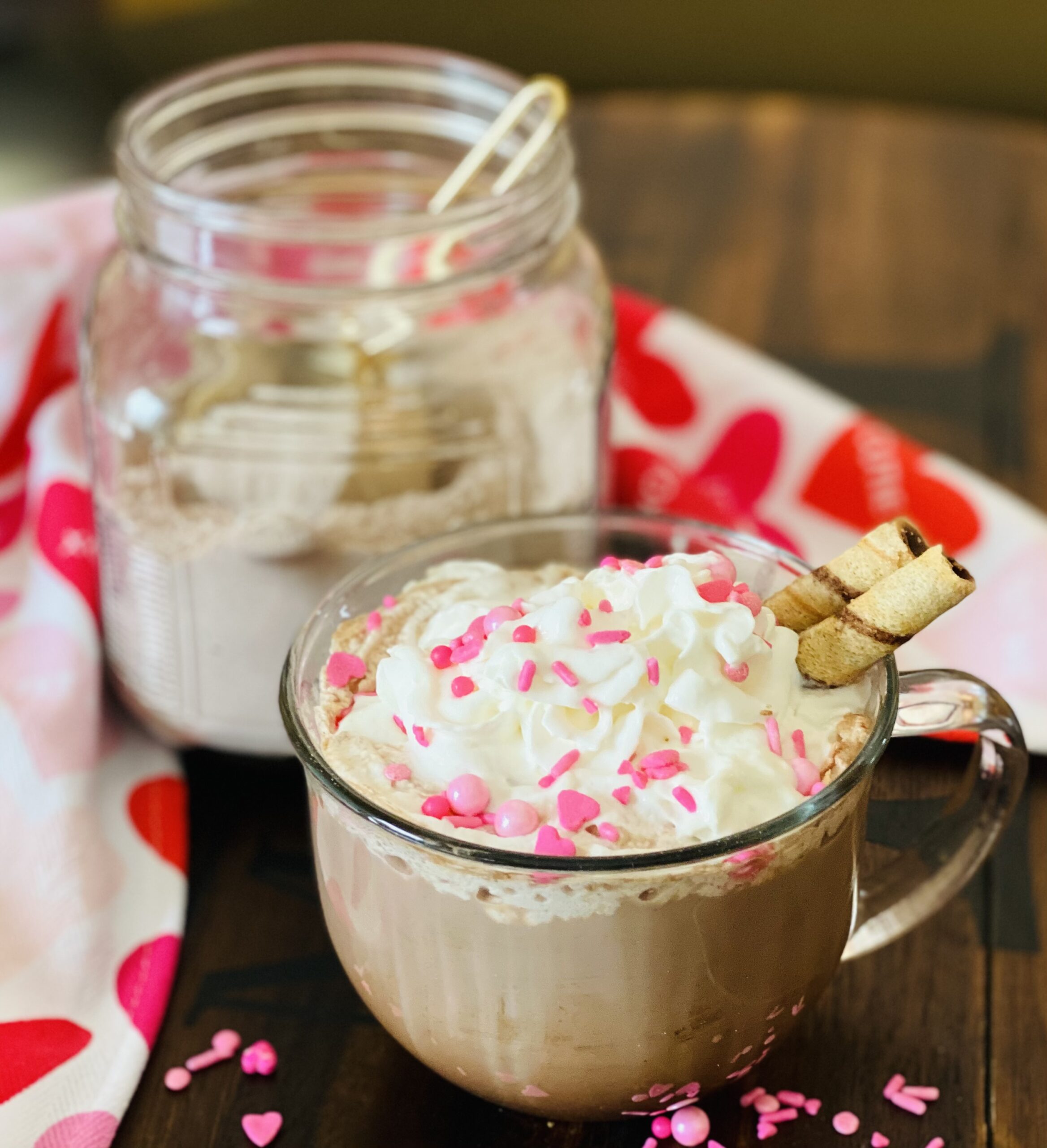 homemade hot chocolate mix in a jar with mug of hot cocoa