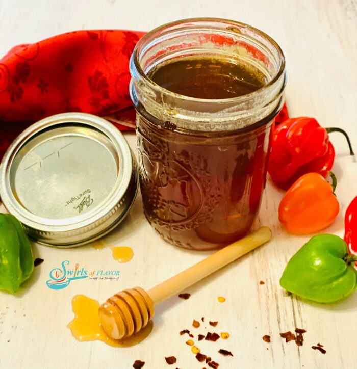 hot honey in mason jar with fresh peppers