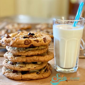 stack of Brown Butter Cookies With Espresso Chips and a glass of mik with a straw