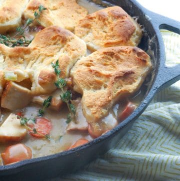 chicken pot pie in a cast iron skillet with one scoop out