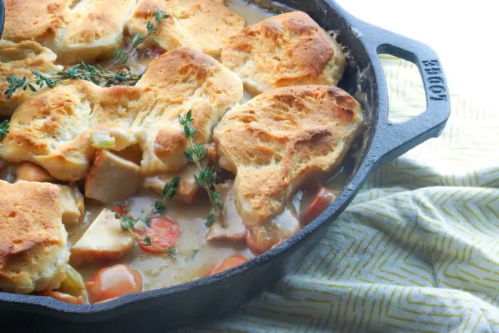 chicken pot pie in a cast iron skillet with one scoop out