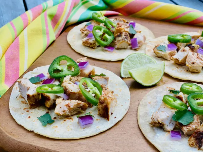 chicken street tacos on a wooden board