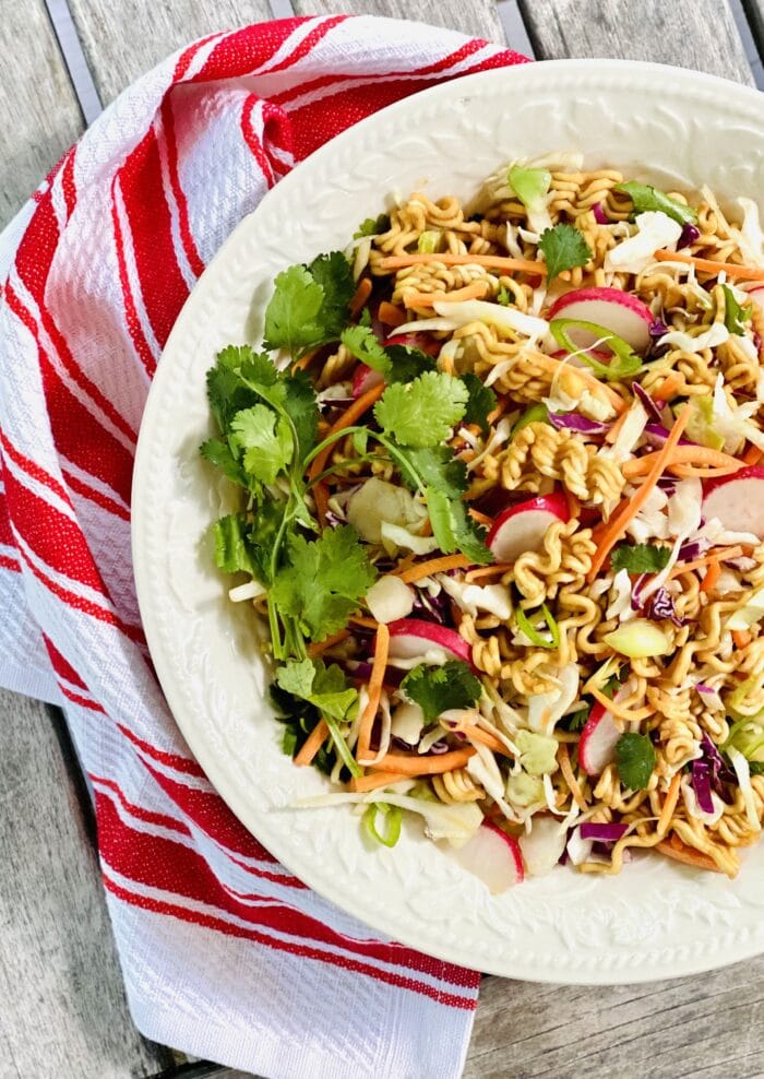 Ramen Noodle Salad Recipe in white dish with red and white napkin