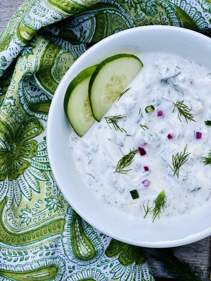 bowl of Tzatziki Sauce with cucumber slices and napkin