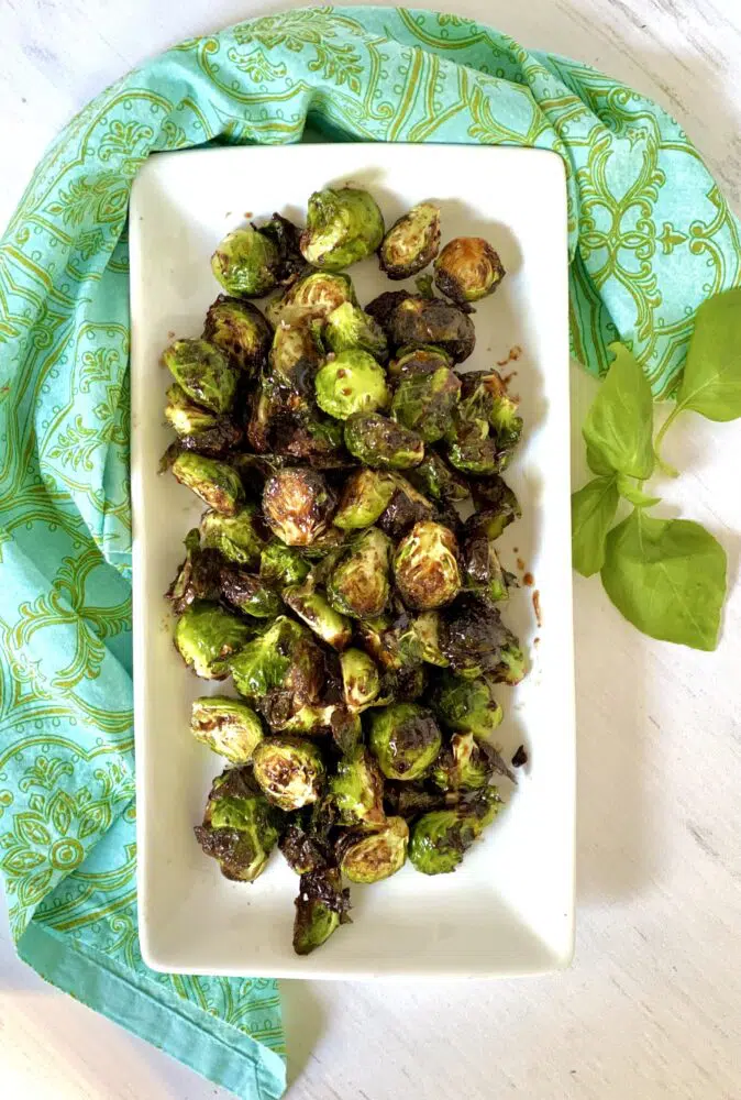 overhead of glazed brussel sprouts in rectangular white dish
