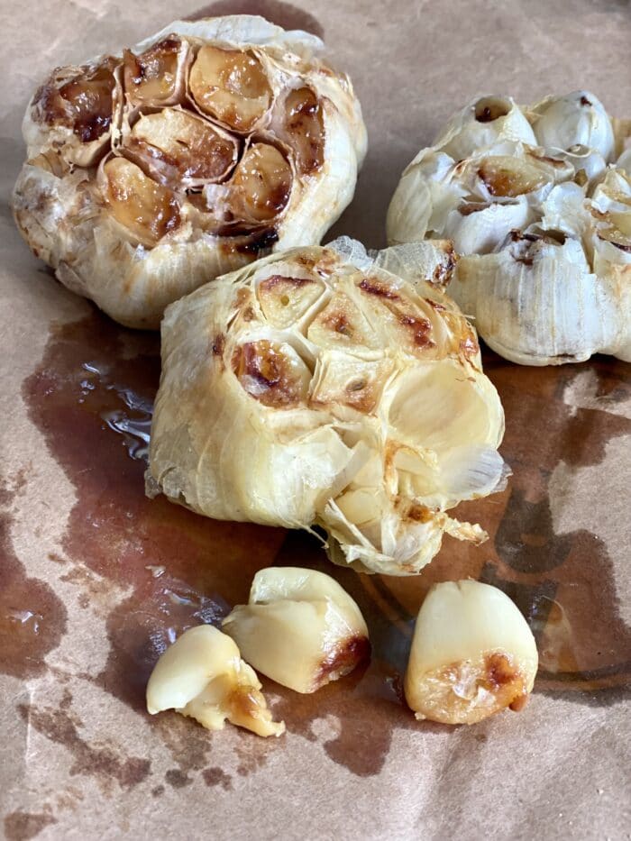 heads of roasted garlic on parchment paper