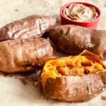 four air fryer sweet potatoes with brown sugar cinnamon butter on parchment paper