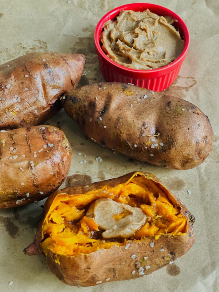 four baked sweet potatoes with brown sugar cinnamon butter