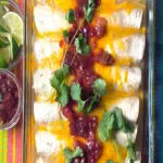 tukrey enchiladas with salsa and cilantro and text overlay