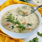 bowl of creamy chicken soup with spoonful