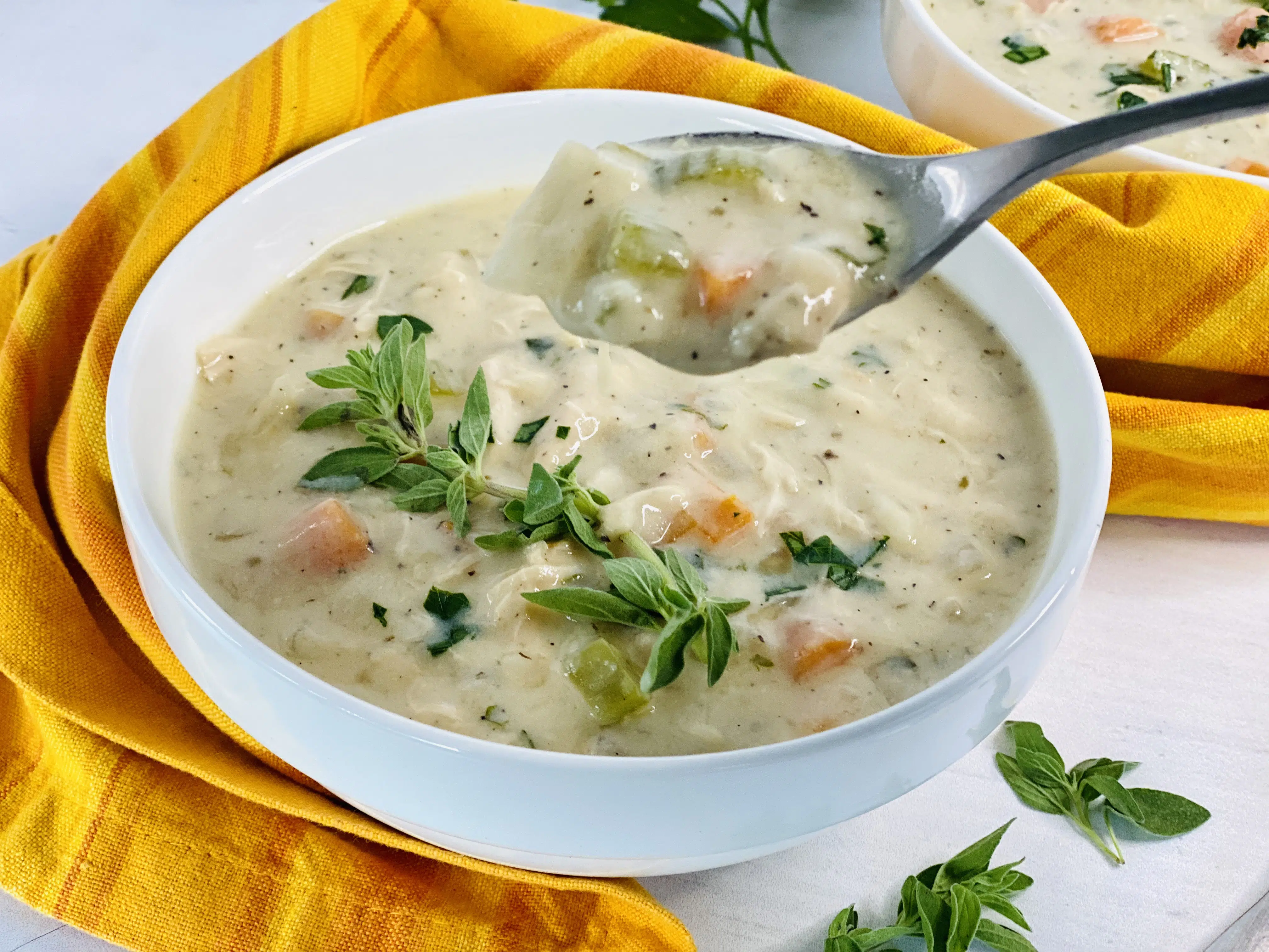 bowl of creamy chicken soup with spoonful