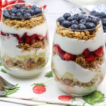 fruit and Greek yogurt breakfast parfaits in stemless glasses