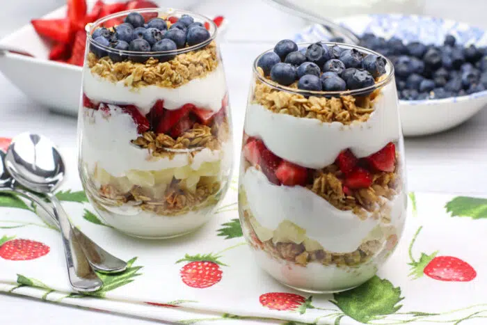 fruit and Greek yogurt breakfast parfaits in stemless glasses