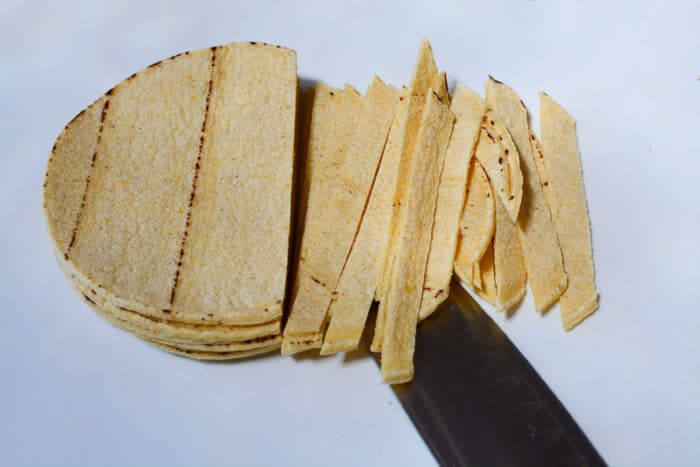 cutting corn tortillas into strips
