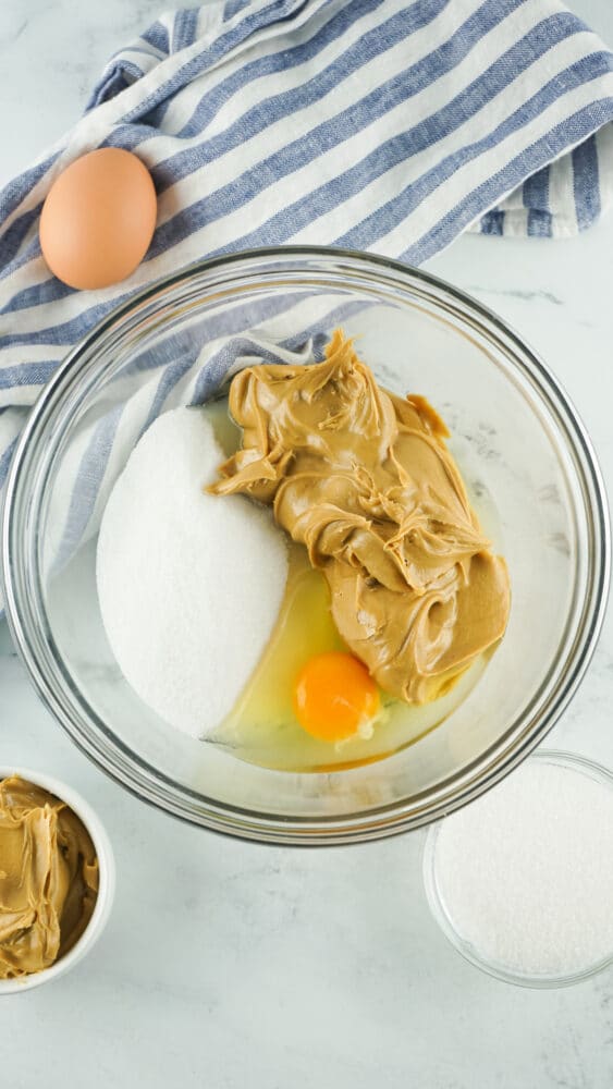 peanut butter, sugar and egg in a bowl
