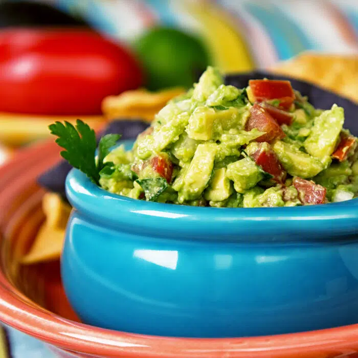 chunky guacamole in blue bowl