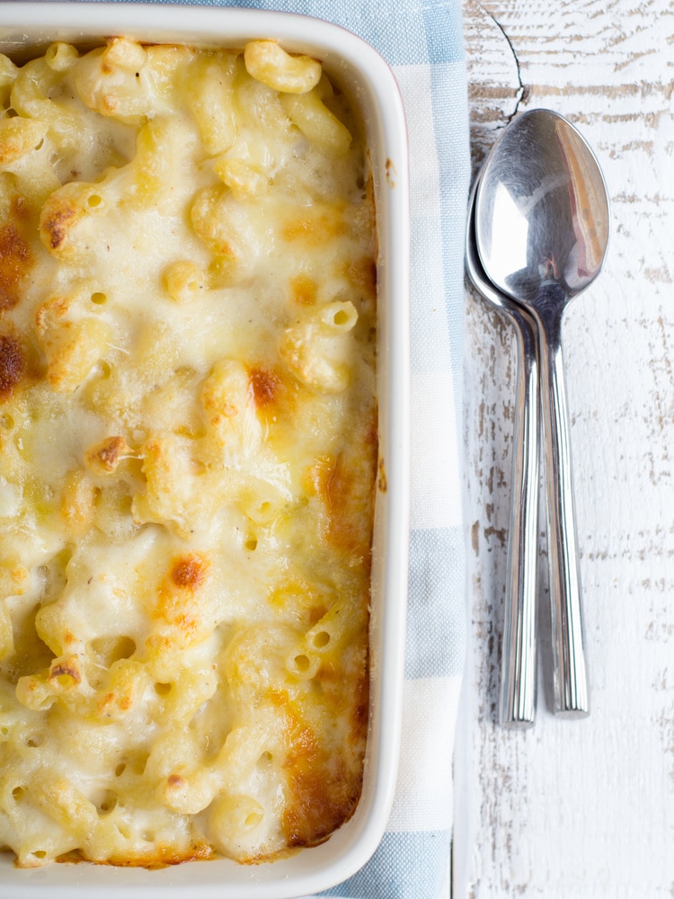 baked macaroni and cheese in baking dish with a spoon
