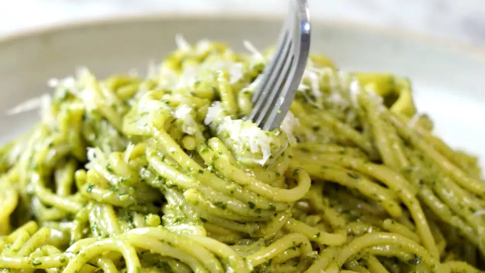 spaghetti with pesto and a fork