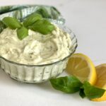 pesto mayo in glass dish with lemon wedges