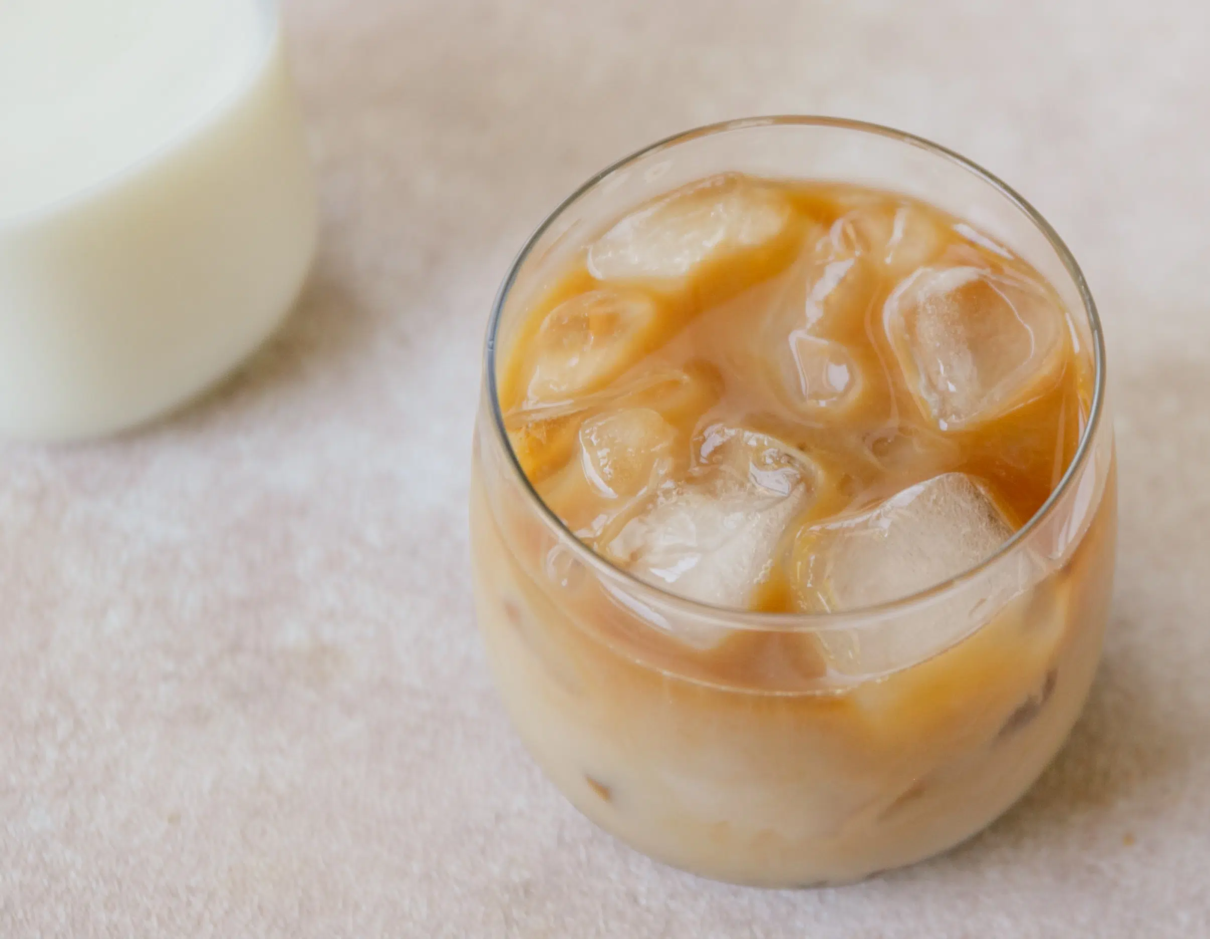 milk with espresso in a glass with ice cubes