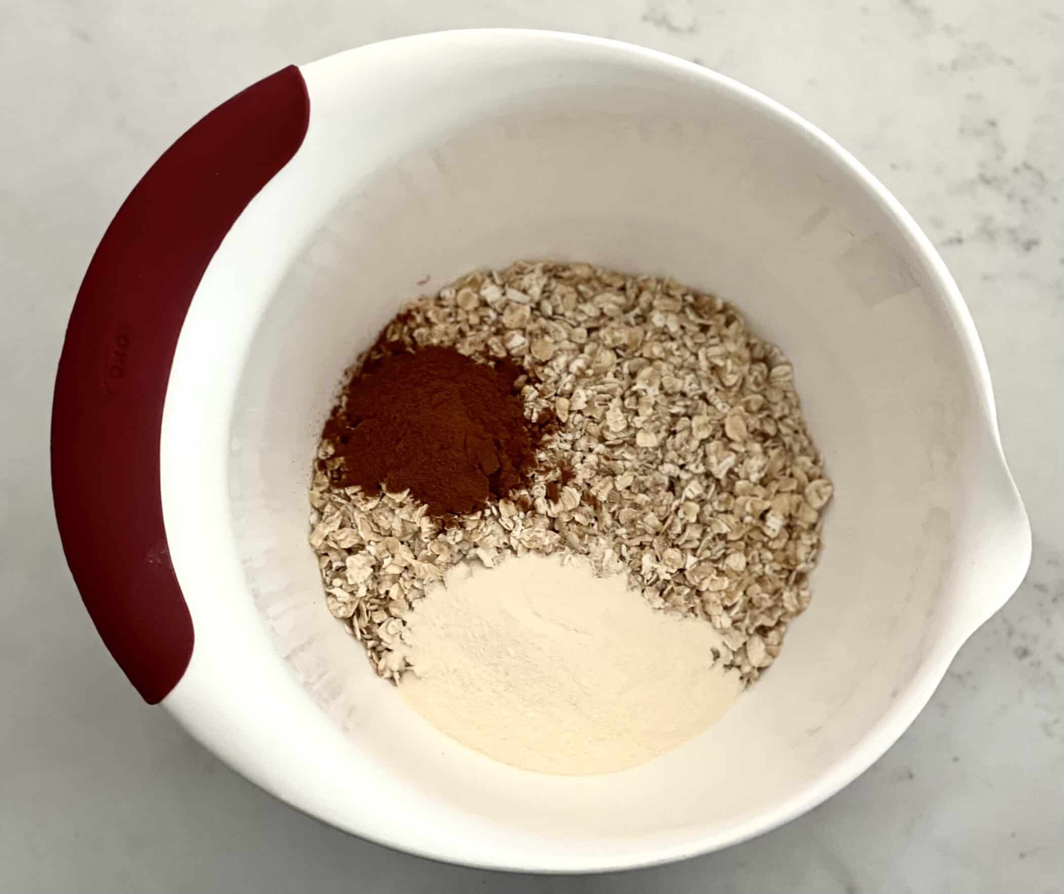 oats, protein powder and cinnamon in mixing bowl