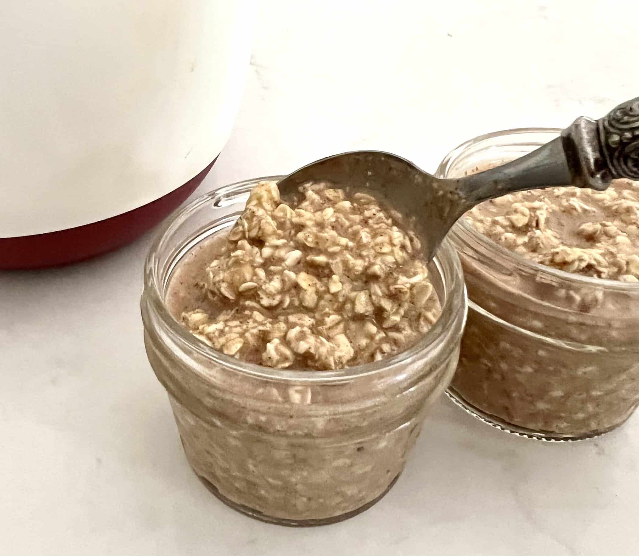 spooning overnight oatmeal into jars