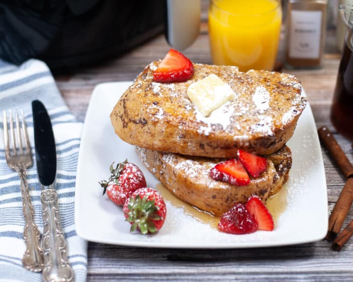 two slices of brown sugar french toast on a white plate