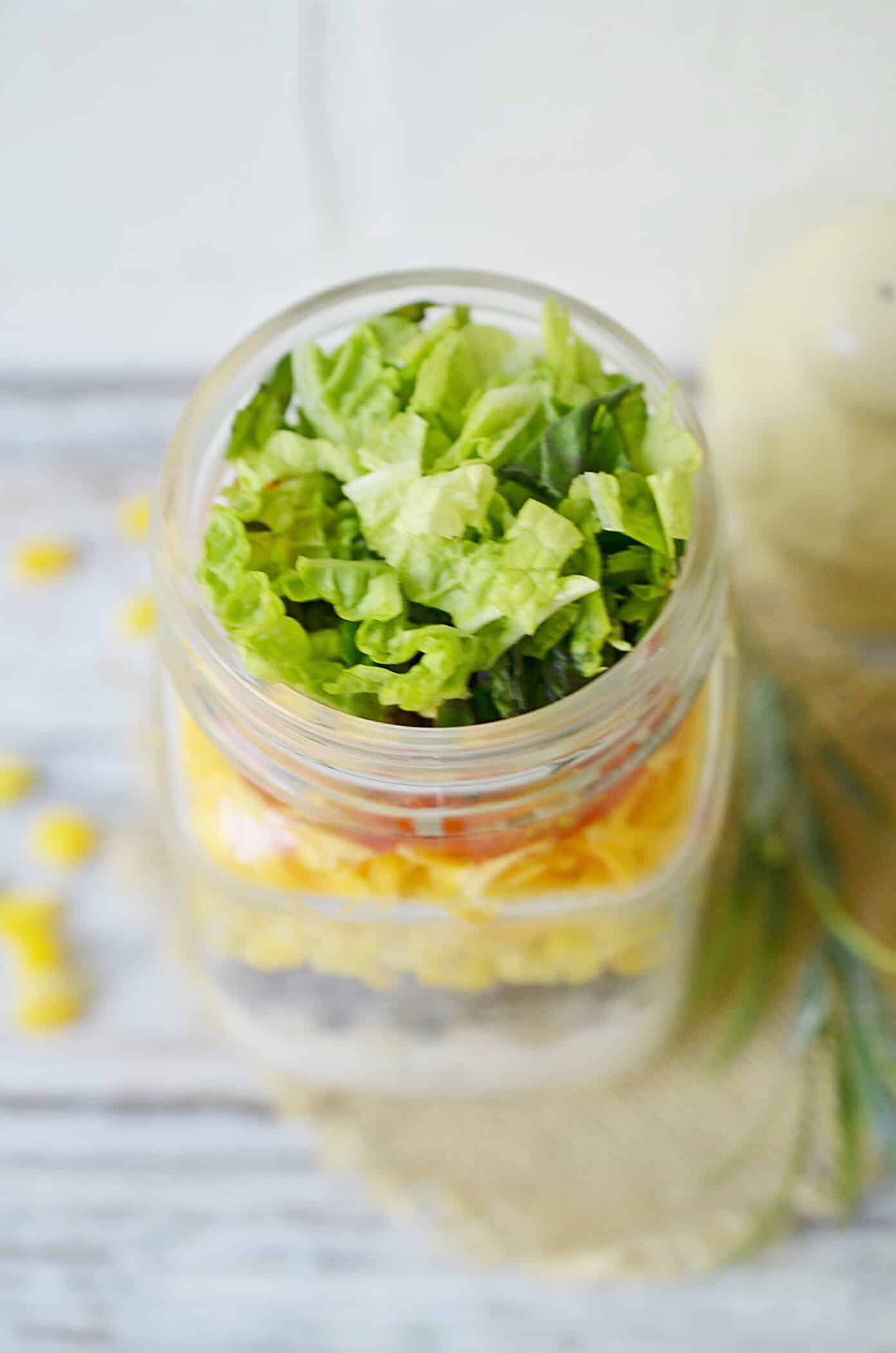 layer of lettuce in a mason jar