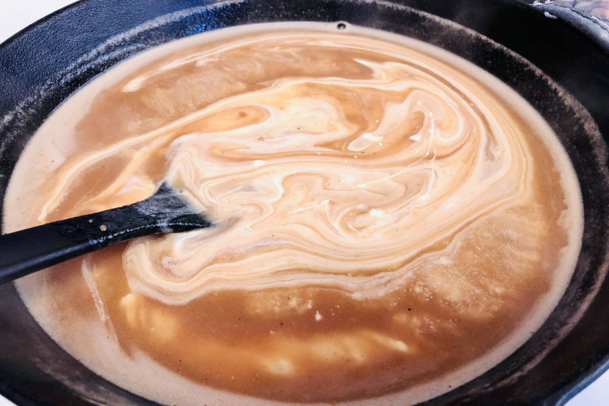 making creamy sauce in the skillet
