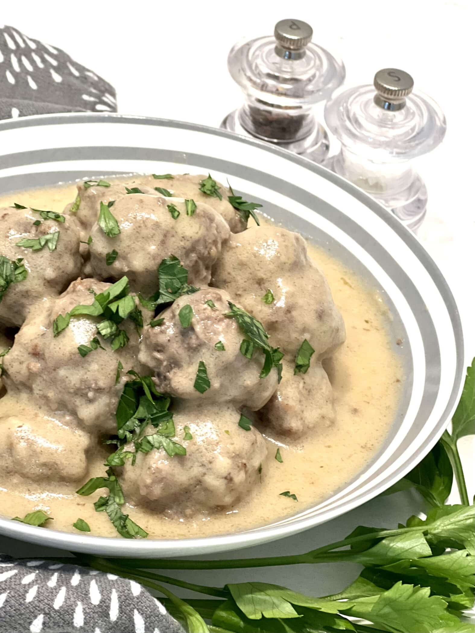 swedish meatballs and sauce in a serving dish