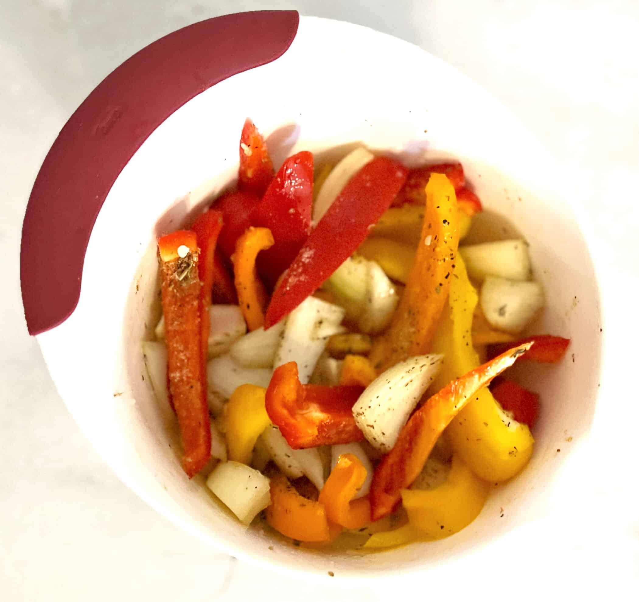 peppers and onions in a mixing bowl