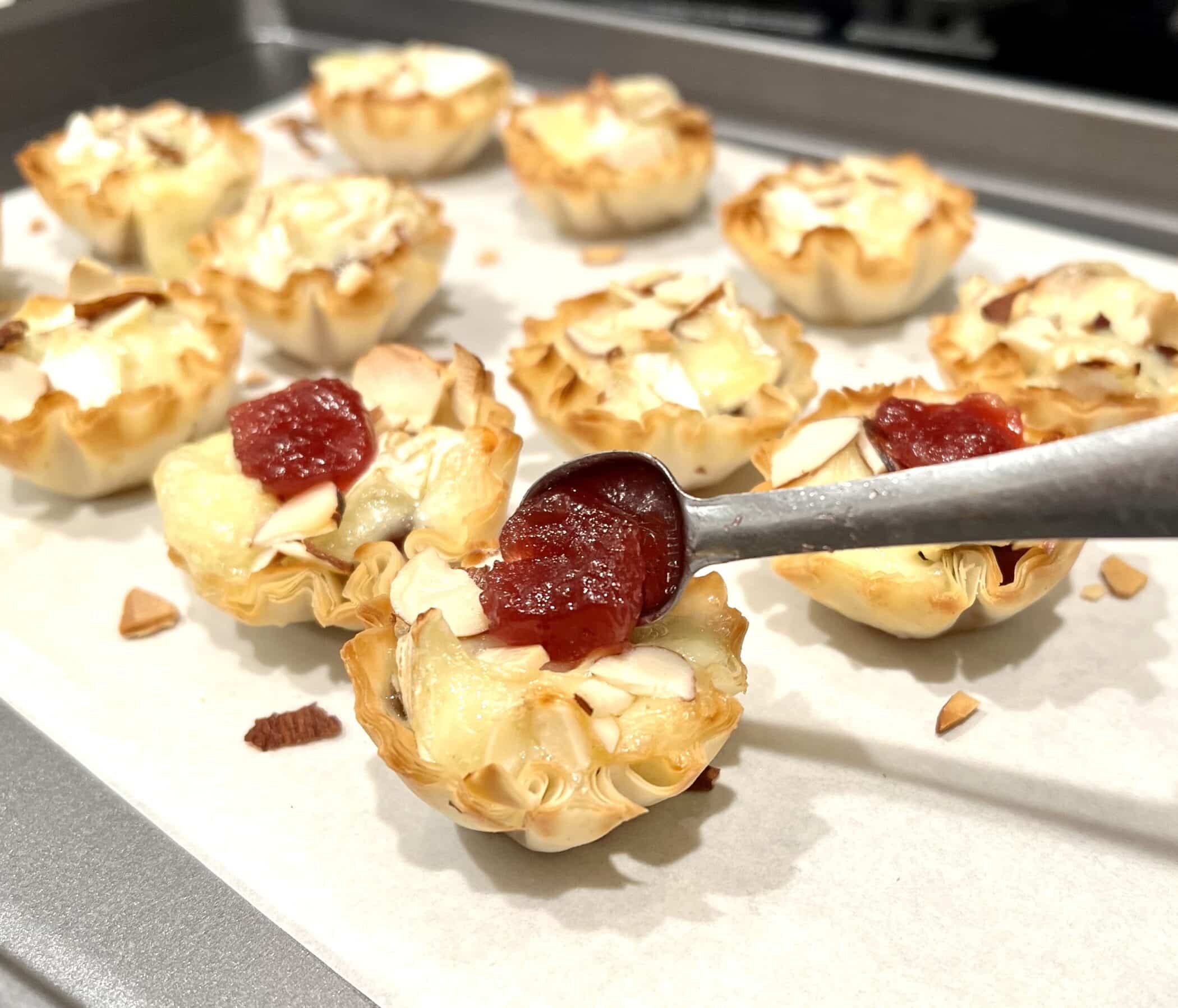 topping Brie cups with cranberry sauce