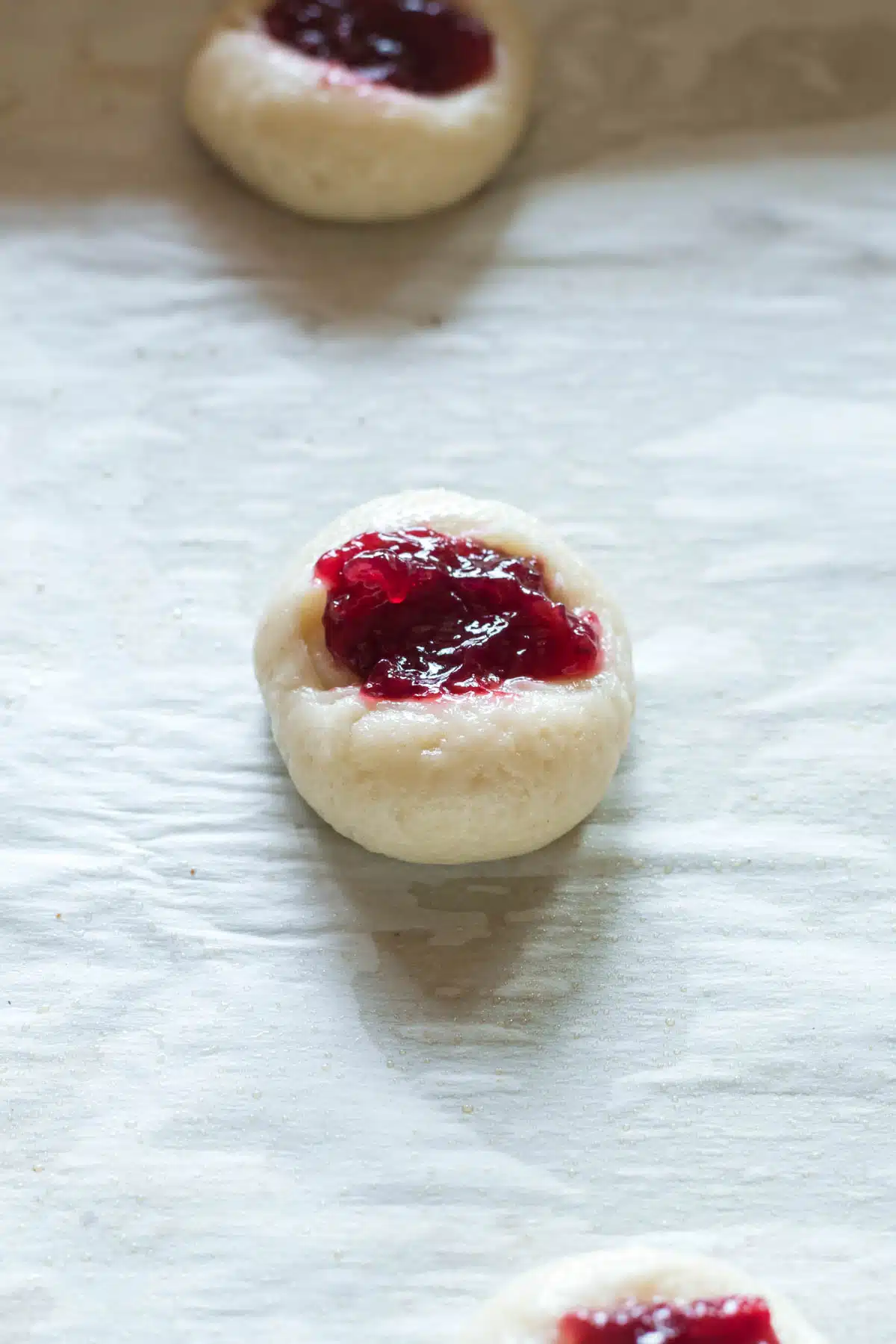 raspberry preserves in center of cookie dough