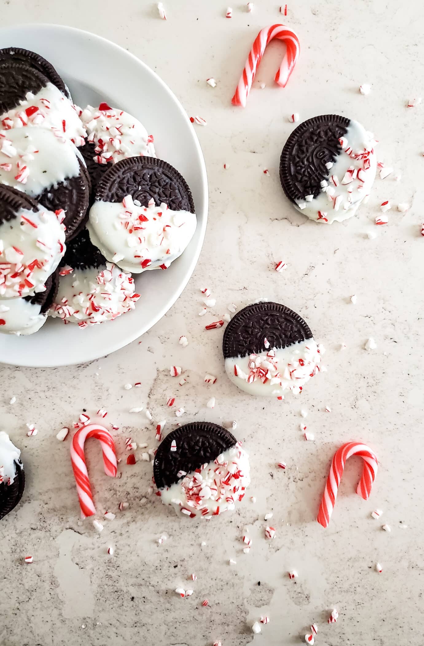 Christmas oreos on a plate with candy canes