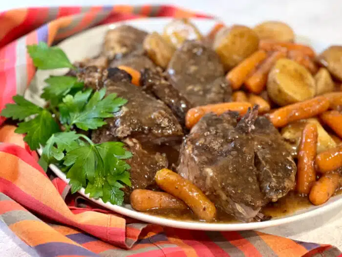 onion soup pot roast with carrots and potatoes on a platter