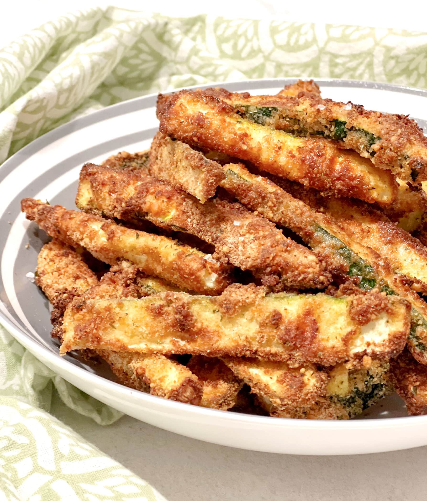 close up of zucchini french fries in a bowl
