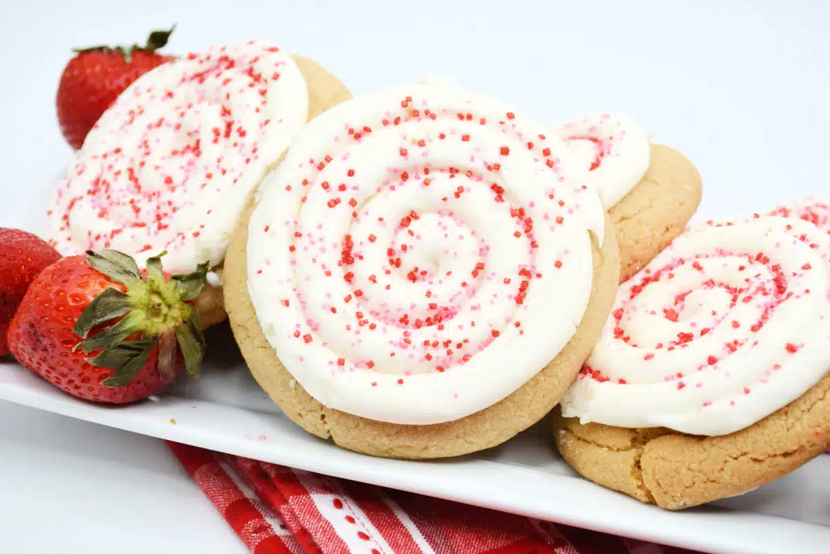 strawberry icing cookies on a long platter