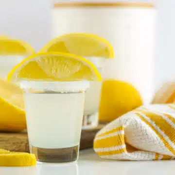 lemon drop shot with lemon wedge and kitchen towel