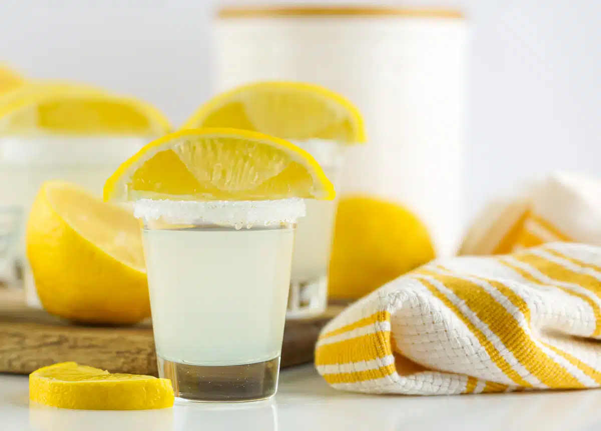 lemon drop shot with lemon wedge and kitchen towel