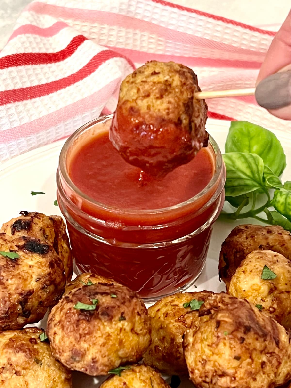 dippng a mini meatball in sauce