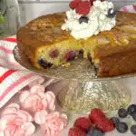 berry cake with slice out and whipped cream