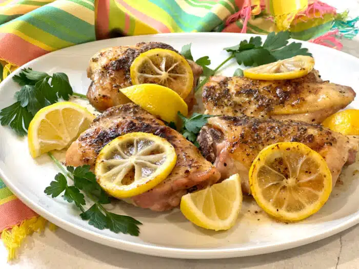 lemon pepper chicken thighs on a platter